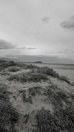 Scenic view of sea against cloudy sky