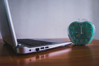 Close-up of clock on table at home