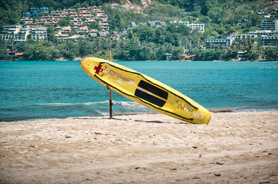 Empty, calm sandy crescent patong beach with turquoise blue clear water and cirrus cloudy sky