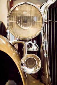 Cropped image of old-fashioned vintage car headlight