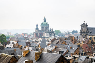 View of buildings in city against clear sky