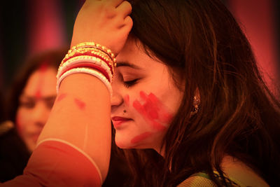 Close-up portrait of young woman with eyes closed