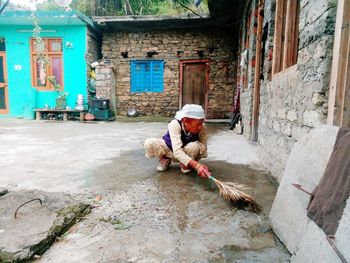 Man working on street against building