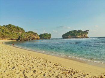 Scenic view of beach against clear blue sky