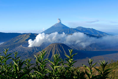 View of volcanic mountain range against blue sky