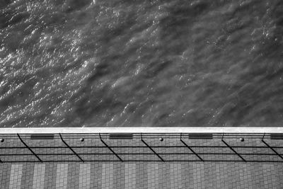 High angle view of railing by sea against sky