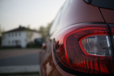 Close-up of red car against sky