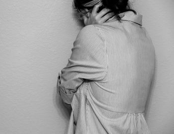 Midsection of woman standing by wall