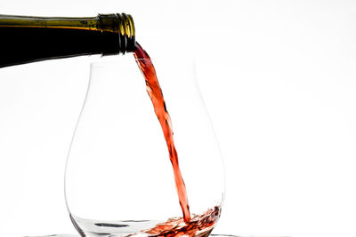Close-up of beer glass bottle against white background