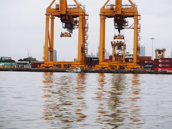 Commercial dock by sea against sky