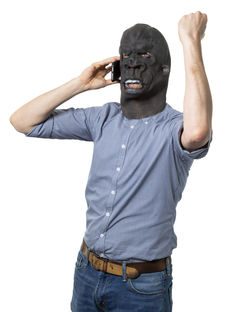 Midsection of man wearing mask against white background