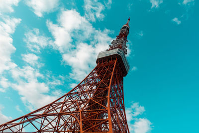 Low angle view of communications tower against cloudy sky