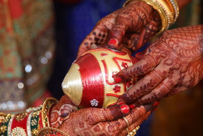 Cropped hands of women during traditional ceremony