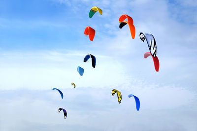 Low angle view of balloons flying against sky