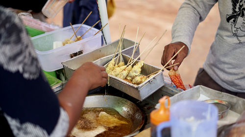 Midsection of man preparing food