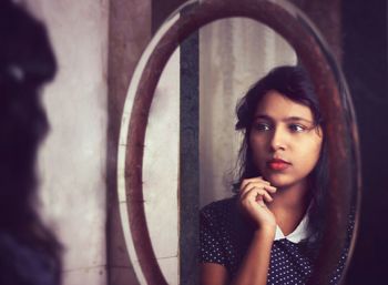 Reflection of woman in mirror at home