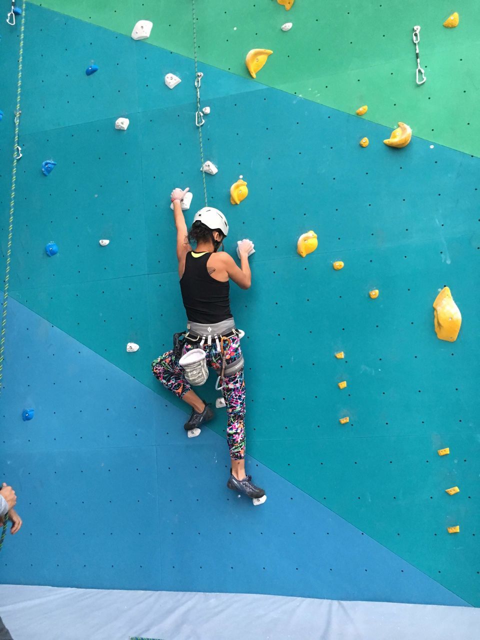 full length, sports, climbing wall, adventure, bouldering, leisure activity, climbing, one person, rock climbing, extreme sports, exercising, lifestyles, adult, activity, recreation, challenge, strength, indoors, child, vitality, men, relaxation, person, balance, skill, young adult, fun, motion, enjoyment, determination, blue, casual clothing, childhood, practicing, nature, day