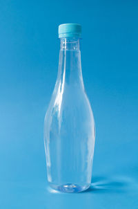 Close-up of bottle against blue background