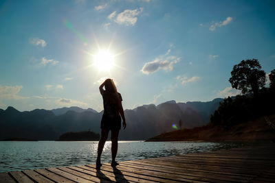 Woman standing on mountain against sky