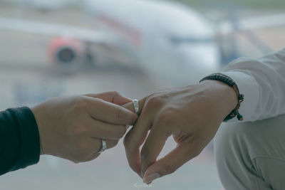 Midsection of couple holding hands