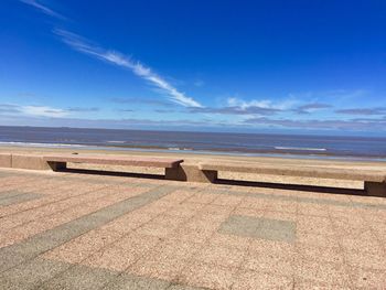 Scenic view of beach against blue sky