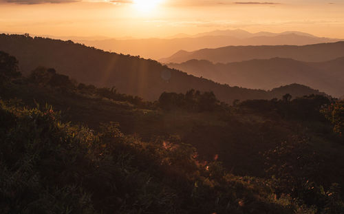 Scenic view of mountains against sky during sunset