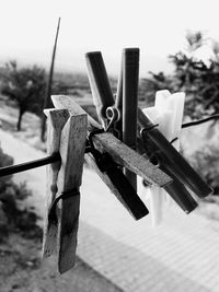 Close-up of clothespins against the sky