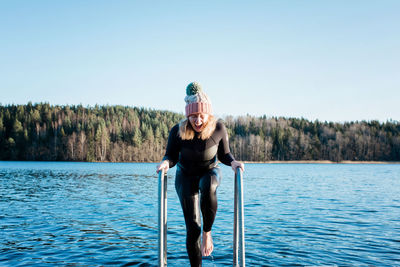 Woman screaming from swimming in the cold water in the sea in winter