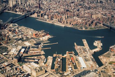 Aerial view of east river amidst cityscape