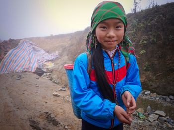 Portrait of smiling woman standing outdoors