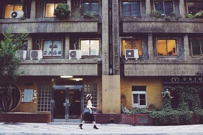 Woman standing in front of building