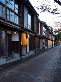 Empty street by buildings in city