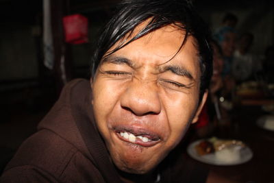 Close-up portrait of man with eyes closed