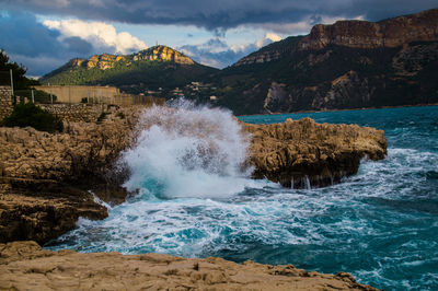 Scenic view of sea and rocks against sky