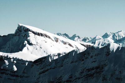 Scenic view of snowcapped mountains against clear sky