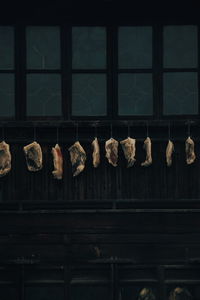 Meat hanging on window in building