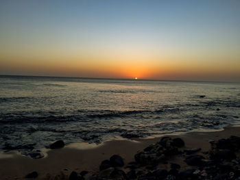 Scenic view of sea against clear sky during sunset