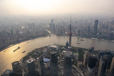 High angle view of city buildings by river