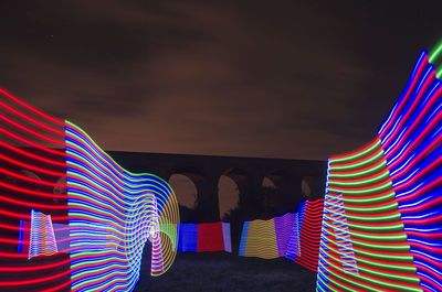 Low angle view of flags at night