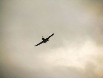 Low angle view of airplane flying in sky