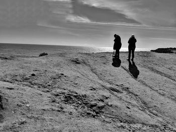 People on beach against sky