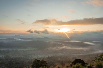 Mountain layers covered with white mist at dawn