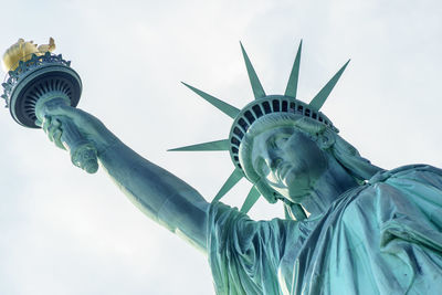 Low angle view of statue of liberty against sky