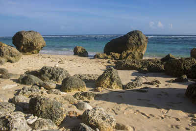 Rocks on beach against sky