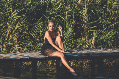 Portrait of young woman sitting in water