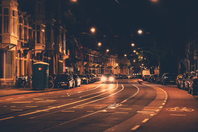 Car on an empty street in city by night