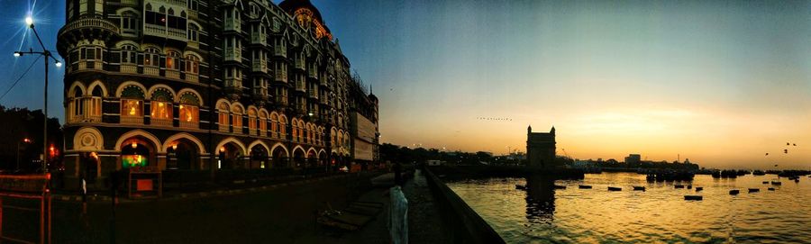 Reflection of buildings in city at sunset