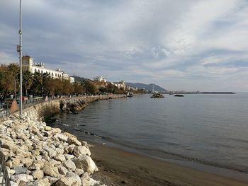 Scenic view of sea against sky in city