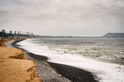 Scenic view of sea against cloudy sky