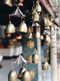 Close-up of bell decorations hanging for sale at market stall